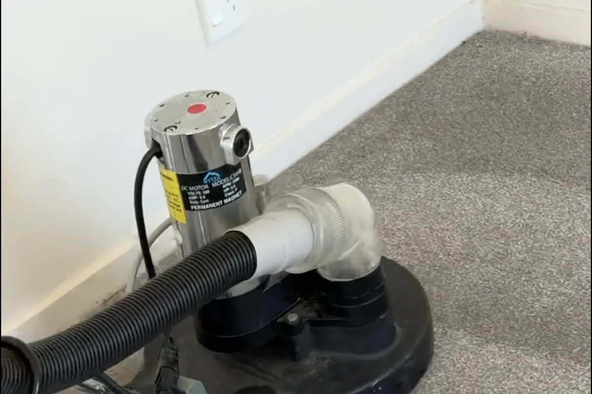 Air movers and a dehumidifier drying carpet after a flood in a Christchurch home